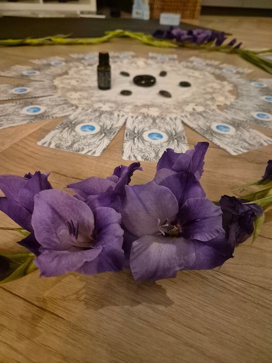 Purple gladioli oracle cards essential oil and Labradorite all set out